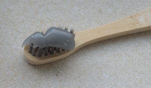 - Encino dentist Dr. Isaac Comfortes, D.D.S. Charcoal toothpaste on a toothbrush - WikiMedia Commons, no author attribution provided